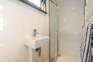 a bathroom with a sink and a shower at 1 Bed in Ponsonby oc-l37879 in Gosforth
