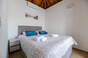 a bedroom with a bed with two towels on it at Holiday house "Maria" in Privlaka +41 photos
