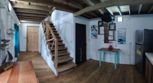 a staircase in a room with a table and a refrigerator at Hotel Tierra Verde in Bocas Town