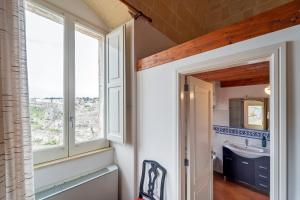 a bathroom with a sink and a window at Dimora Santa Barbara in Matera +45 photos