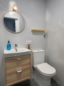 a bathroom with a toilet and a sink and a mirror at Apartamento Galvana in Peniscola +13 photos