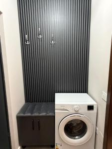 a washer and dryer in a small bathroom at Sofia Apartment in Galaţi