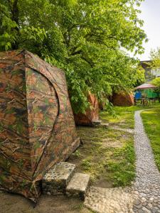 an open umbrella sitting on a stone bench at Friends glamping & Sauna in Kutaisi