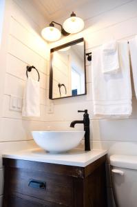 a bathroom with a sink and a mirror at NEW! Cozy Container Home at Cliffside #5 in Orderville