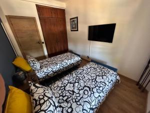 a hotel room with two beds and a flat screen tv at Margem Rio Residence in Sacavém