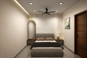 a bedroom with a bed and a ceiling fan at विठाई AC Rooms in Pandharpur