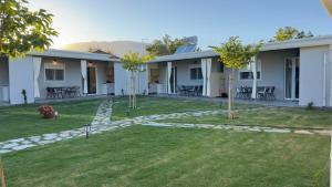a house with a lawn in front of it at Anemos Comfort Living in Paralia Panteleimonos