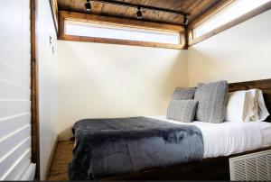 a bedroom with a bed in a room with a window at NEW! Modern Cabin Tiny Home at Cliffside #1 in Orderville