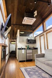 a kitchen and living room in a tiny house at NEW! Modern Cabin Tiny Home at Cliffside #1 in Orderville +16 photos