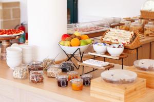 a buffet with a bowl of fruit and other food at Masseria Tenuta Specolizzi in Lido Marini