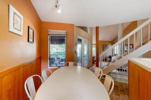 a dining room with a white table and chairs at Hawks Nest 27 in Glen Arbor