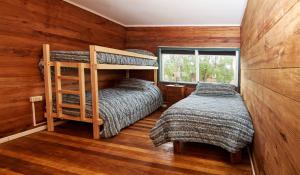 a bedroom with two bunk beds and a window at Hostel Café MESTIZO in Osorno +15 photos