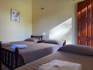 a group of three beds in a room at Complejo Foecyt Santa Fe in Colastiné
