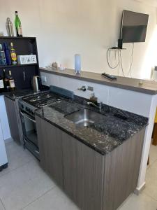 a kitchen with a sink and a stove at Shackleton in Wilde +4 photos