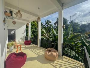 a porch with two bean bags on a house at SIlvas Surf Home in Weligama +52 photos
