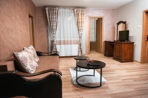 a living room with a couch and a table at Hotel Rion in Mangalia