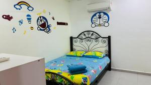 a bedroom with a bed and stickers on the wall at LCS Homestay in Pangkor