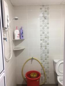 a bathroom with a shower with a bucket in it at LCS Homestay in Pangkor