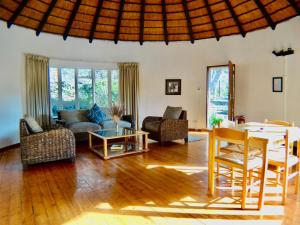 a living room with a couch and a table at Forestiva Farm - River Cottage in Centurion