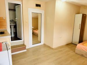 a room with a mirror and a room with a bed at Room Nencheva in Sandanski