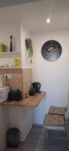 a counter in a room with a clock on the wall at Centralhome in Miskolc