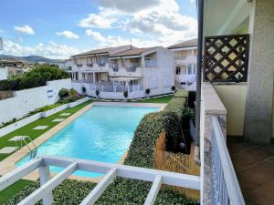 a view of a swimming pool from the balcony of a house at Seaside Home - Palau in Palau
