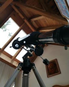 a telescope in a room with a wooden ceiling at Private Stunning Cottage In Forest Cuernavaca CDMX in Huertas de San Pedro