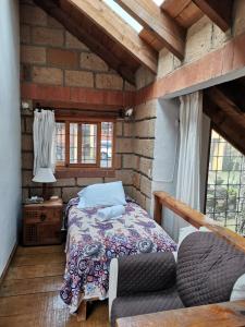 a bedroom with a bed and a brick wall at Private Stunning Cottage In Forest Cuernavaca CDMX in Huertas de San Pedro