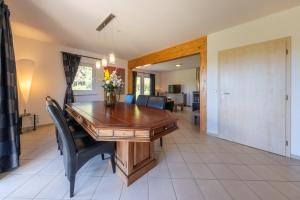 a dining room with a wooden table and chairs at Villa Gamma - Lipno Home in Lipno nad Vltavou