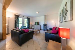 a living room with two couches and a table at Villa Gamma - Lipno Home in Lipno nad Vltavou