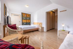 a room with two beds and a table and chairs at Villa Gamma - Lipno Home in Lipno nad Vltavou +39 photos