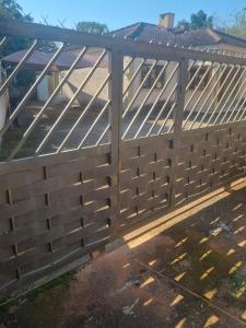 a fence with a gate in a yard at Melos Cosy Retreat in Ezulwini