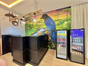 a large painting of a bird on the wall of a store at Hotel Planalto Serrano in Curitibanos