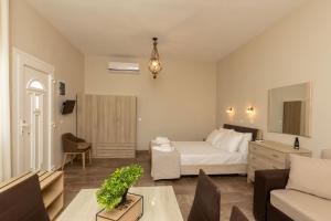 a bedroom with a bed and a living room at Ancora in Skala Potamias