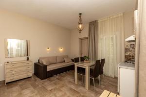 a living room with a couch and a table at Ancora in Skala Potamias