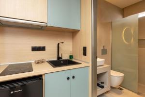 a small kitchen with a sink and a toilet at Ancora in Skala Potamias +103 photos