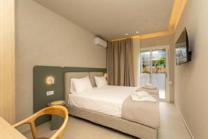 a small bedroom with a bed and a window at Ancora in Skala Potamias