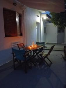 a table and chairs in a courtyard at night at Summer House 96 in Salamina +14 photos