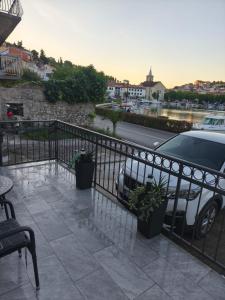 a car parked on a balcony with a fence at Apartman Cvitan in Zaton +4 photos