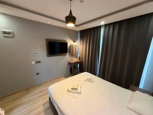 a hotel room with a bed and a television at The Basilissis Gulhane in Istanbul