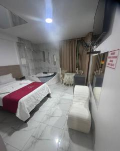 a hotel room with a bed and a bath tub at hotel dominicos & parkas in Lima