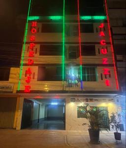 a building with green and red lights on it at hotel dominicos & parkas in Lima