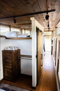 a tiny house with a bed and a hallway at NEW! Modern Cabin Tiny Home at Cliffside #3 in Orderville