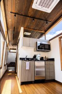 a kitchen with a sink and a stove at NEW! Modern Cabin Tiny Home at Cliffside #3 in Orderville +16 photos