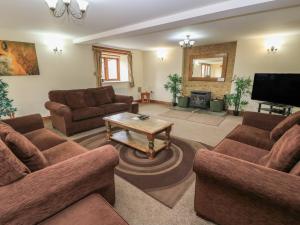 a living room with couches and a coffee table at Tithe Barn, Lyneham in Bruern