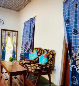 a living room with a couch and a table at Moonlight Villa in Pottuvil