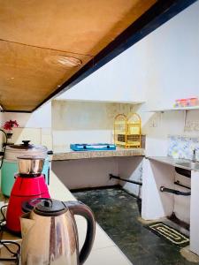 a kitchen with a tea kettle on a counter at Moonlight Villa in Pottuvil +21 photos
