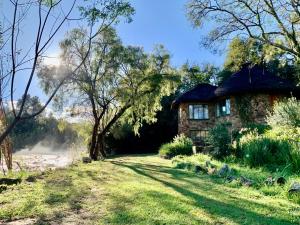 an old stone house on the side of a river at Forestiva Farm - River Cottage in Centurion