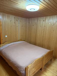 a bedroom with a bed in a wooden room at KarpatskeDzerelo in Roztoky +14 photos