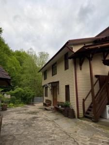 a white house with a porch and a patio at KarpatskeDzerelo in Roztoky